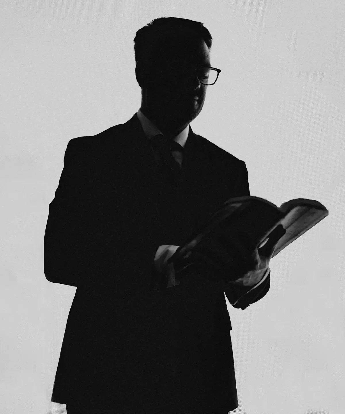 Silhouette of a lawyer reading in a quiet office